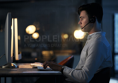 Buy stock photo Call center, night office and employee typing, working late shift or overtime for commission. Crm, contact us and telemarketing, sales agent or support worker in dark office consulting on computer.
