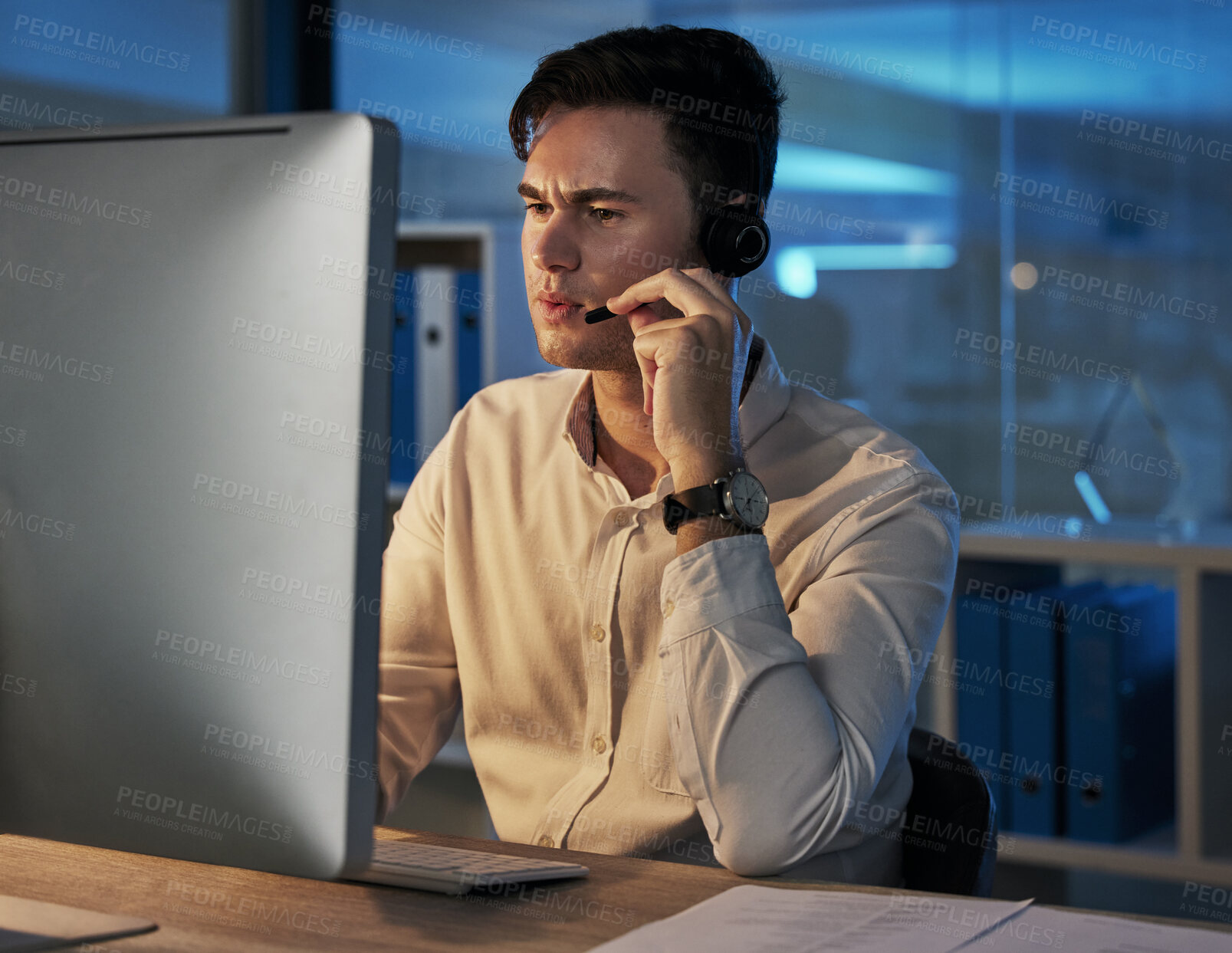 Buy stock photo Businessman, telemarketing and consulting working at night in the office for customer service or advice. Man in contact us, consultation or help with headset for insurance, investing or communication