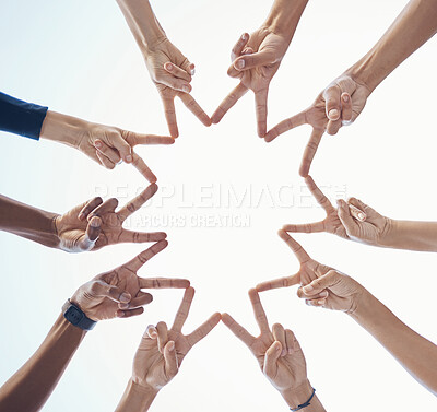 Buy stock photo Diversity, teamwork and hands with star shape for community, team building or support with a sky background. Collaboration, peace and bottom view of group of people with fingers in unity for bonding.