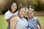 Black woman, children and nature park of a family together with a smile and hug bonding outdoor. Portrait of mother, garden and girl siblings with happiness, love and care feeling positive in summer
