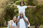 Portrait of a happy black family in nature to relax bonding in freedom, wellness and peace together in a park. Mother, father and child loves flying, hugging or playing outdoors enjoying quality time