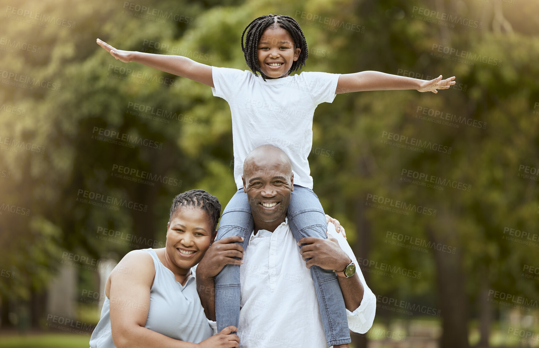 Buy stock photo Portrait of a happy black family in nature to relax bonding in freedom, wellness and peace together in a park. Mother, father and child loves flying, hugging or playing outdoors enjoying quality time