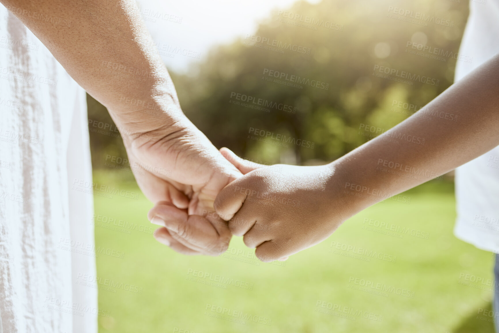 Buy stock photo Park, family and parent holding hands with child bonding together enjoying nature and outdoors. Summer, love and hands of young kid with adult bonding, carefree on weekend, holiday and vacation