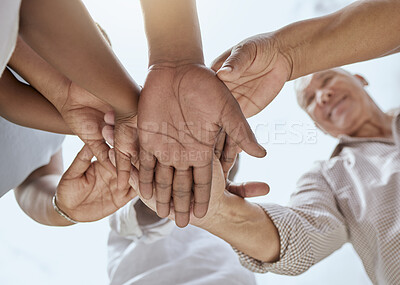 Buy stock photo Community, support and hands of family in nature with bottom view for growth, happy or teamwork mindset. Mission, health and trust with hand stack of people against blue sky for goals, future or hope