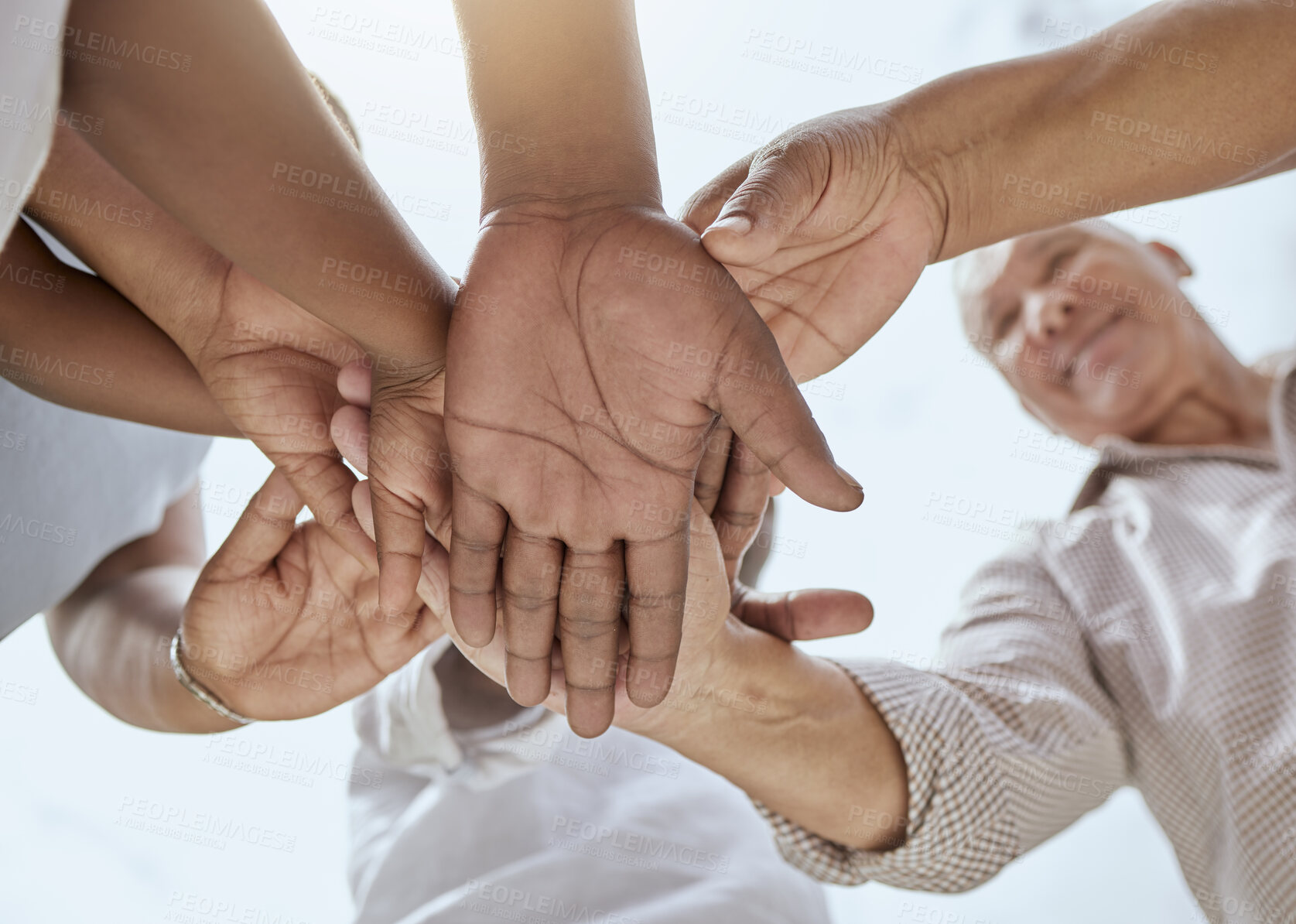 Buy stock photo Community, support and hands of family in nature with bottom view for growth, happy or teamwork mindset. Mission, health and trust with hand stack of people against blue sky for goals, future or hope