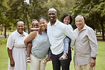 Big family, happiness and love while outdoor at a park for bonding, support and quality time on vacation with children, parents and grandparents. Portrait of men, women and kids in nature for fun