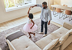 Man, father or girl ballet dancing in living room of house or happy family home in energy, ballerina tutu or dress in top view. Dad, child or dancer kid bonding in creative comic fun in South Africa