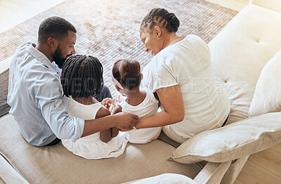 Buy stock photo Black family, care and love while bonding on living room couch with children, mother and father together with trust and support. Man, woman and young kids sitting on sofa to relax from top view