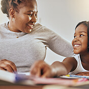 Mother with young girl, learning with books in home and studying for ...