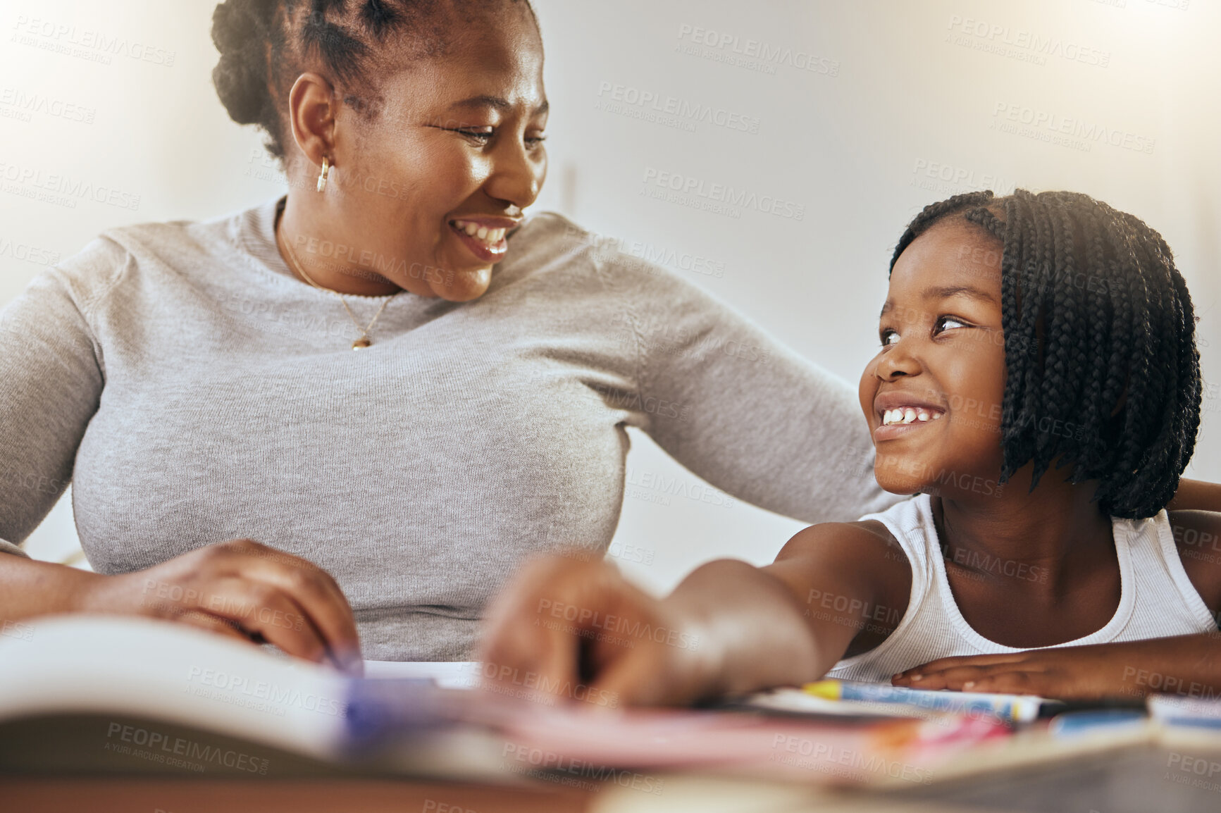 Buy stock photo Mother with young girl, learning with books in home and studying for test in Kenya. Homeschooling education, happy child writing homework and mama helping daughter with knowledge development