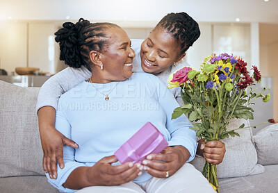 Buy stock photo Black woman, mothers day and hug with flowers on sofa for love, box or gift to mom in home. Woman, bouquet and senior mama with wow, smile or happy for surprise, celebration or birthday on couch