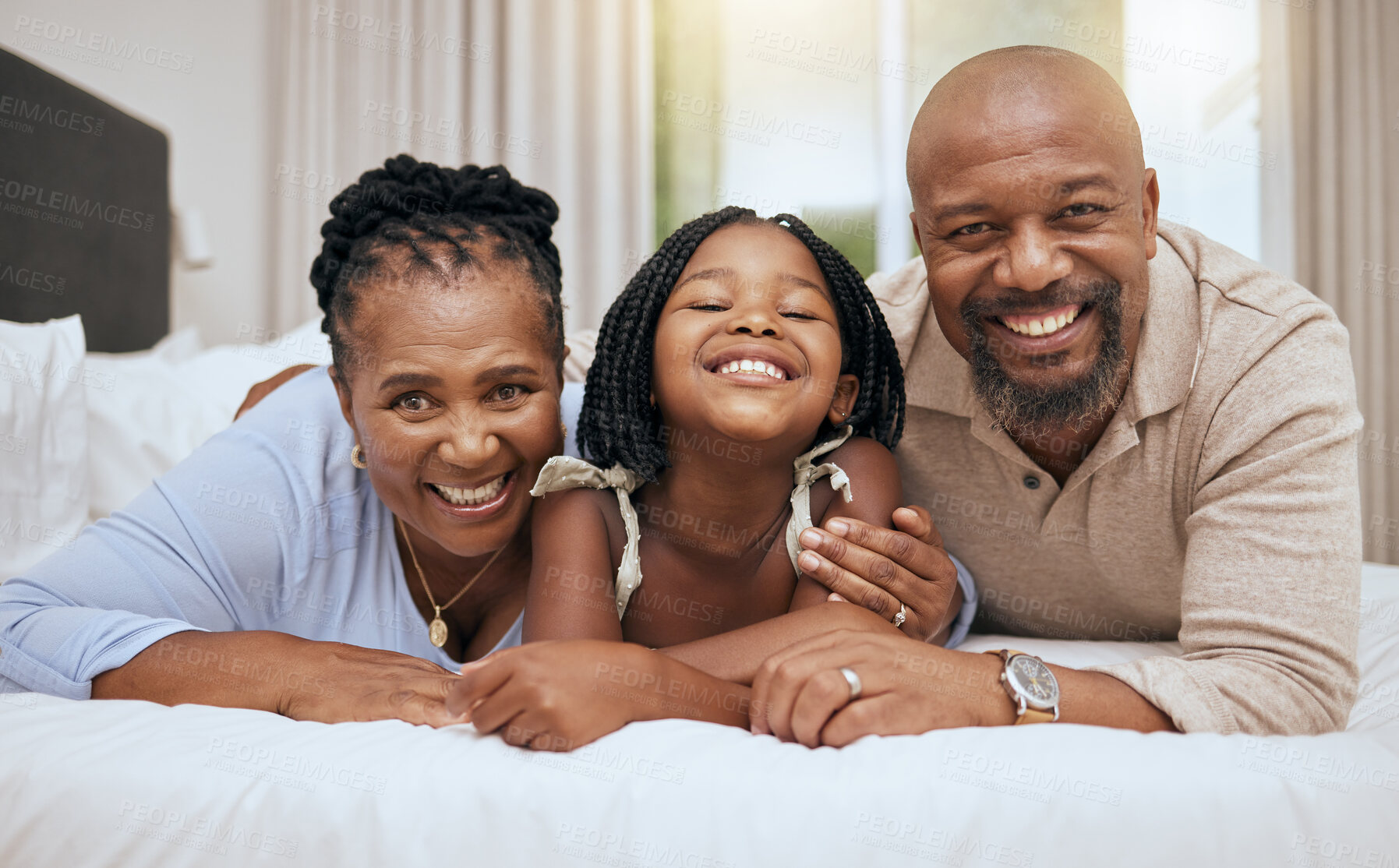 Buy stock photo Black family, bed and relax together in bedroom at home for relationship bonding. Happy family, parents smile and excited child portrait, smiling or lay in morning for happiness in family home