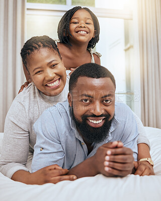 Buy stock photo Love, black family and with girl on bed, happy or smile together for bonding, loving and fun. Portrait, mother and father or parents with daughter in bedroom, quality time and happiness on break