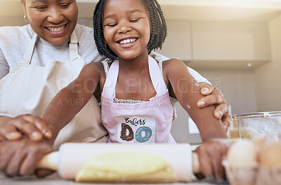 Buy stock photo Baking, mother and child helping in the kitchen, learning and smile for rolling dough together in a house. Food, happy and African mom teaching a girl kid to bake or cooking in their family home