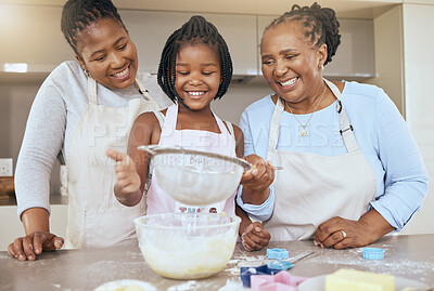 Buy stock photo Happy family, child and cooking in kitchen together for bonding or learning development activity. Black family, grandmother and mother teaching kid baking skills for independence in retiement home