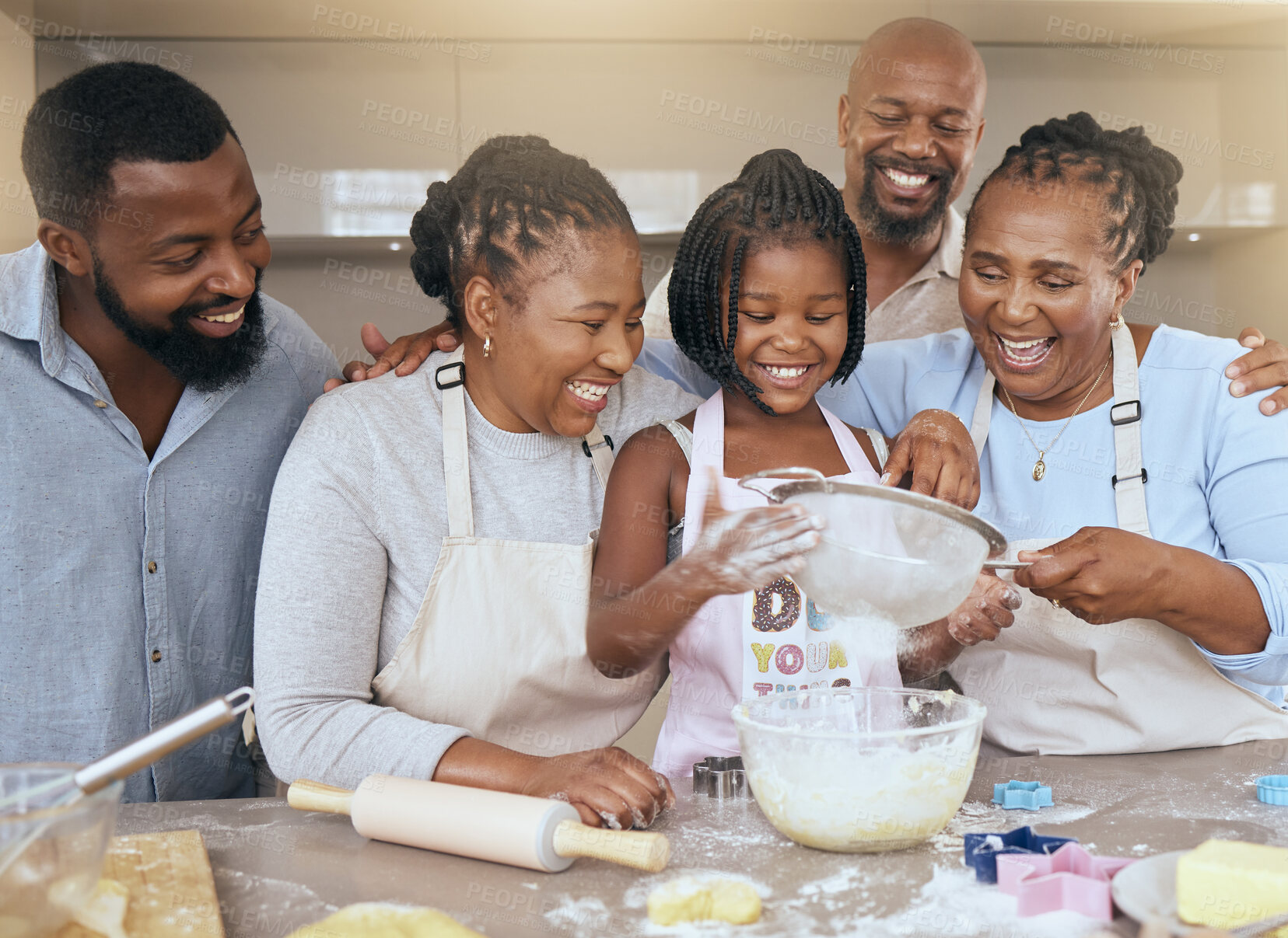 Buy stock photo Big family, baking and learning while teaching girl to bake in kitchen counter, love and fun together in home. Black dad, mom and grandparents with kid with food, ingredients and flour for breakfast
