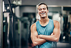 Fitness, gym and happy portrait of personal trainer man ready for workout coaching. Training, wellness and exercise coach confident with arms crossed at professional athlete health club.