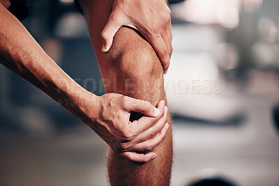 Buy stock photo Fitness, exercise and man with knee pain in the gym, closeup of hands holding knee after injury. Sports, health and hurt male athlete with sore joint in leg after workout, training and exercising