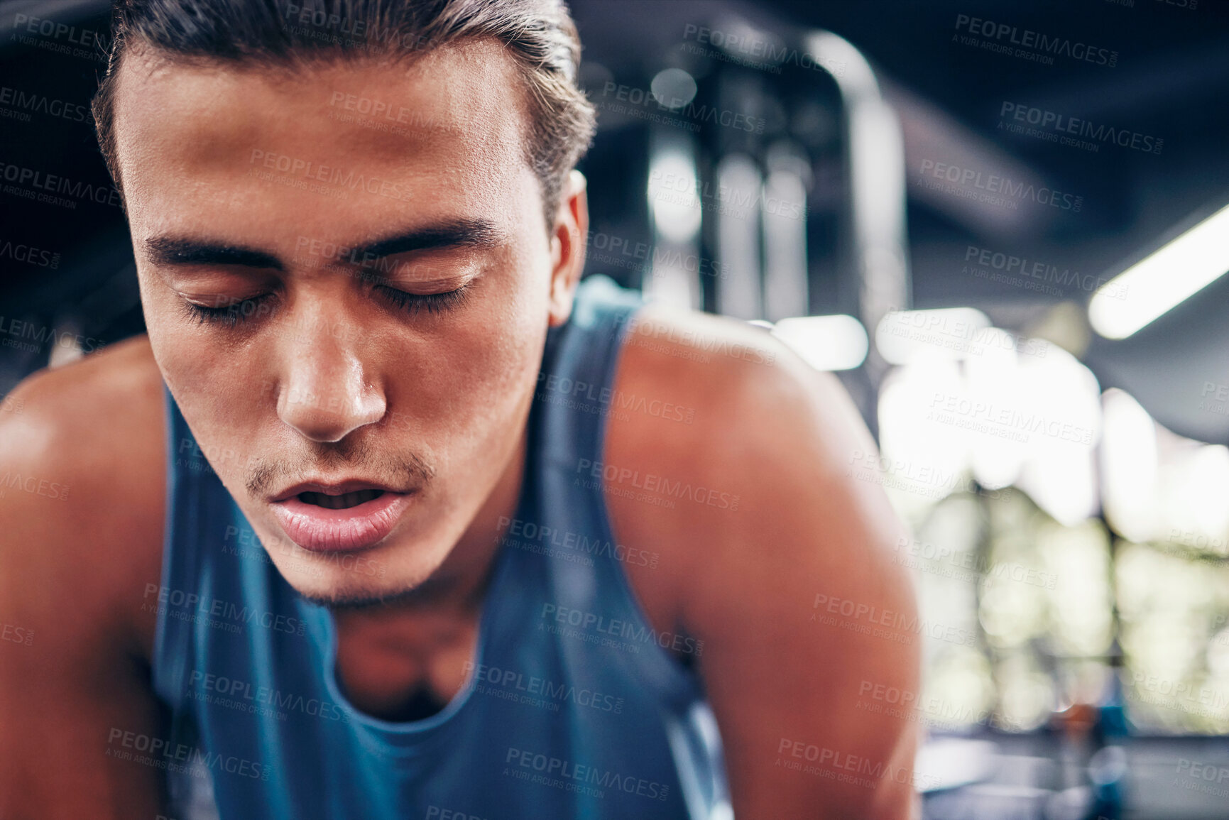 Buy stock photo Tired, gym and fatigue man breathing, break and workout, training or exercising inside a wellness club. Young athlete or cardio guy bending after his fitness strength or muscle exercise for health