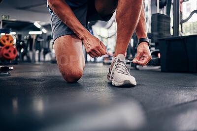 Buy stock photo Hands, gym and man tie shoes preparing for training, running or exercise. Sports, fitness or male athlete in health studio getting ready for cardio, workout or bodybuilding practice in fitness center