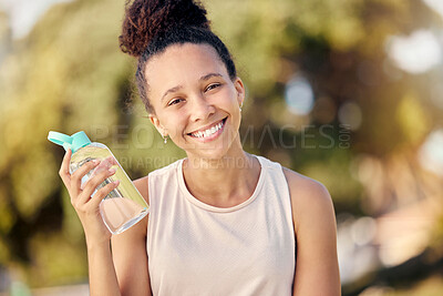 Buy stock photo Water bottle, fitness and nature of black woman in portrait for outdoor exercise, wellness and healthy diet lifestyle in park or forest. Trees bokeh, workout and sports girl with drinking water gear