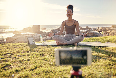 Buy stock photo Yoga, meditation and technology with woman in nature for live streaming, peace or social media with phone and tablet. Relax, fitness or health with zen influencer by ocean for video, internet or blog