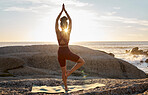 Peace, yoga and sunset with woman at beach on rocks for fitness, zen and meditation wellness. Relax, spiritual and faith with girl training by ocean for balance, workout or breathing health in nature