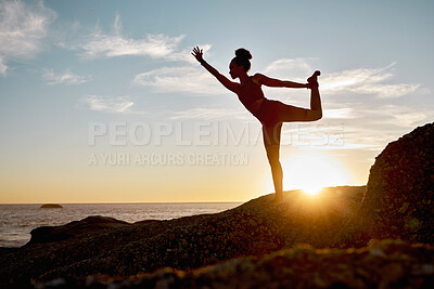 Buy stock photo Fitness, woman and yoga stretching on the beach during sunset for spiritual wellness, training or workout. Active female in calm, zen or warm up stretch for healthy exercise posing on a ocean rock