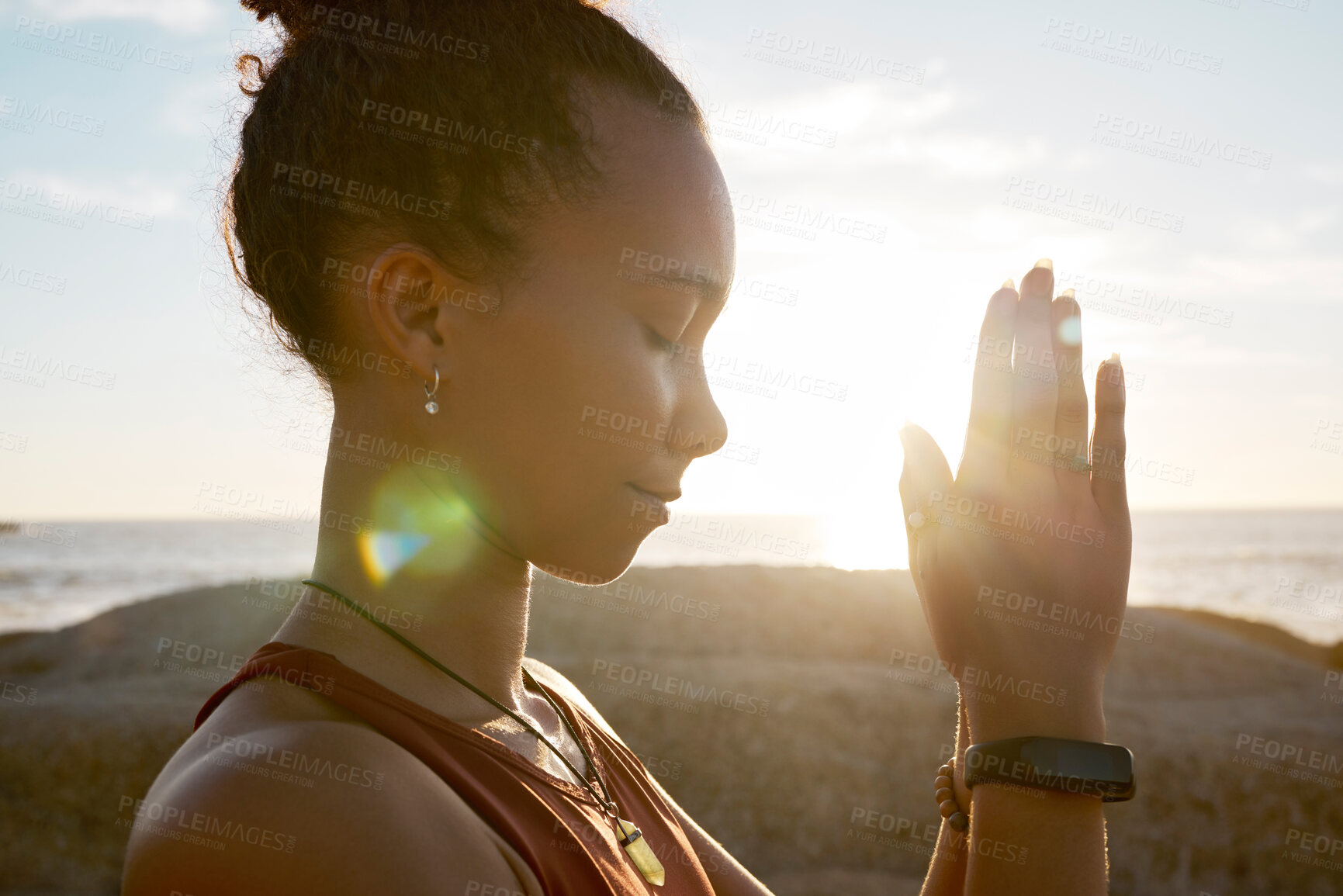 Buy stock photo Meditation, beach flare and yoga girl meditate for spiritual balance, healthcare wellness or chakra energy healing. Namaste, nature sunset and training black woman with peace, freedom and zen mindset