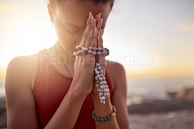 Buy stock photo Prayer, beach and hands of woman with beads for meditation, calm and peace in nature. Motivation, yoga and spiritual black woman praying by ocean for mindfulness, wellness and healthy body in morning