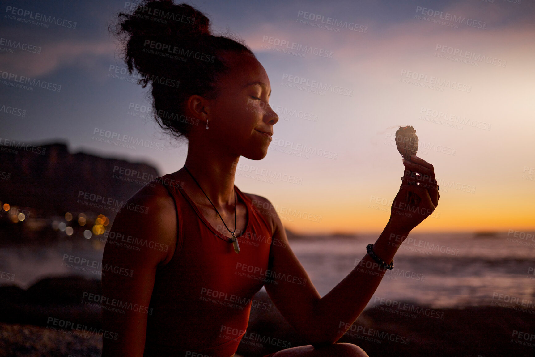 Buy stock photo Beach meditation, sunset and yoga woman with sage aromatherapy smoke for aura, soul or chakra energy healing.   Zen mindset, pilates mindfulness and black girl meditate for twilight spiritual balance