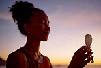 Black woman, meditation and mindfulness, burning sage for zen and cleanse, therapy and spiritual healing outdoor. Ritual at sunset, aromatherapy and wellness for positive energy and healthy mindset.