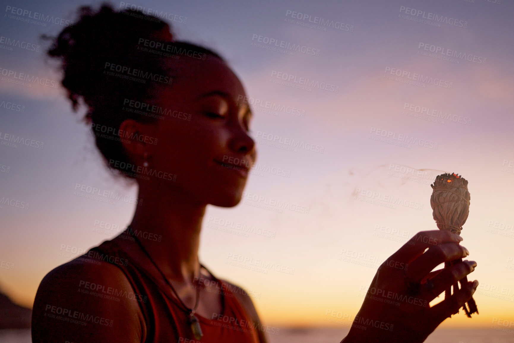 Buy stock photo Black woman, meditation and mindfulness, burning sage for zen and cleanse, therapy and spiritual healing outdoor. Ritual at sunset, aromatherapy and wellness for positive energy and healthy mindset.