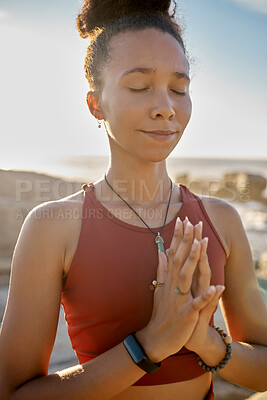 Buy stock photo Yoga, meditation and praying black woman at beach for spiritual, wellness and healing with zen, nature and mindfulness. Sports, calm and prayer hands girl meditate for faith, peace and health by sea