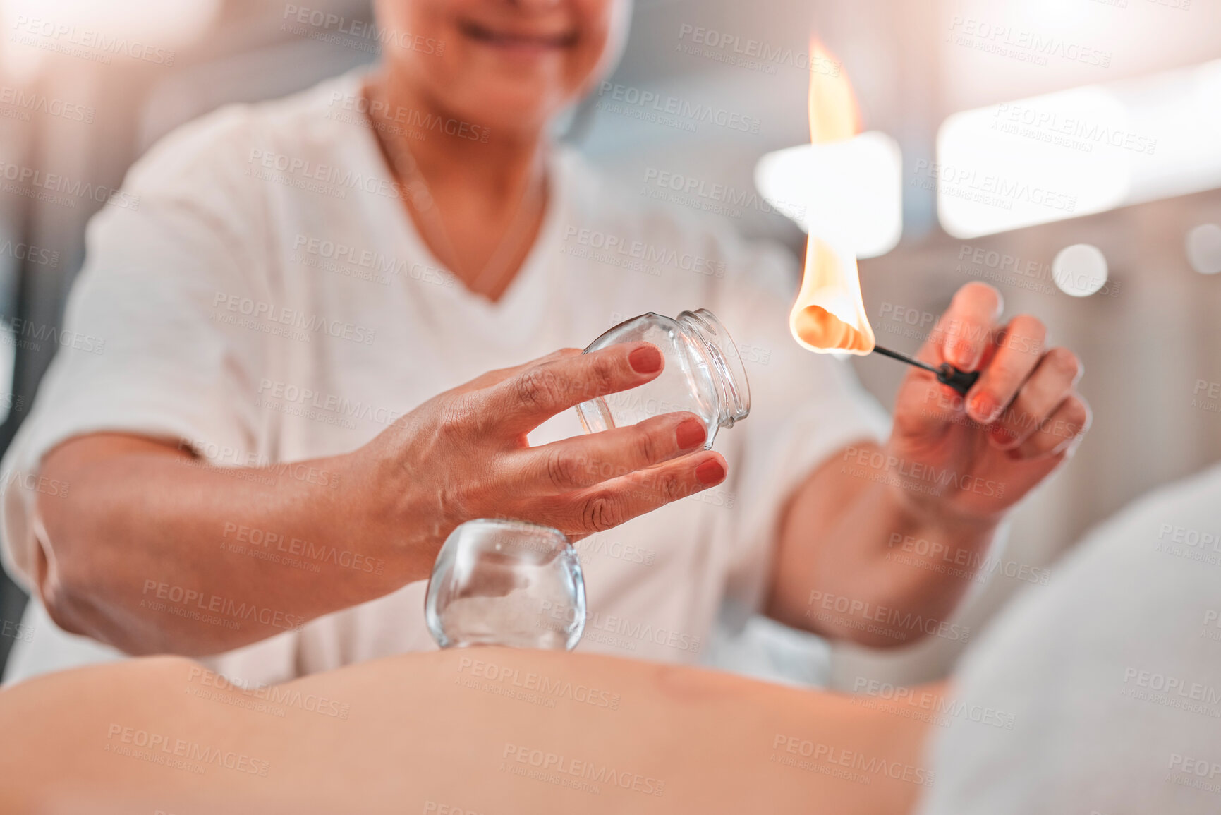 Buy stock photo Woman, hands or flame for cupping therapy in spa, hotel salon or holistic Chinese treatment for pain relief, muscle stress or injury. Zoom, massage therapist or fire in glass cup for wellness healing