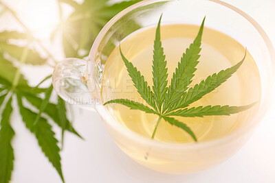 Buy stock photo Weed, cannabis and leaf in a tea for anxiety, stress relief medicine and relaxing natural plants. Cbd, healthcare and green healing marijuana flower herbs in water for a trippy 420 detoxing drink 