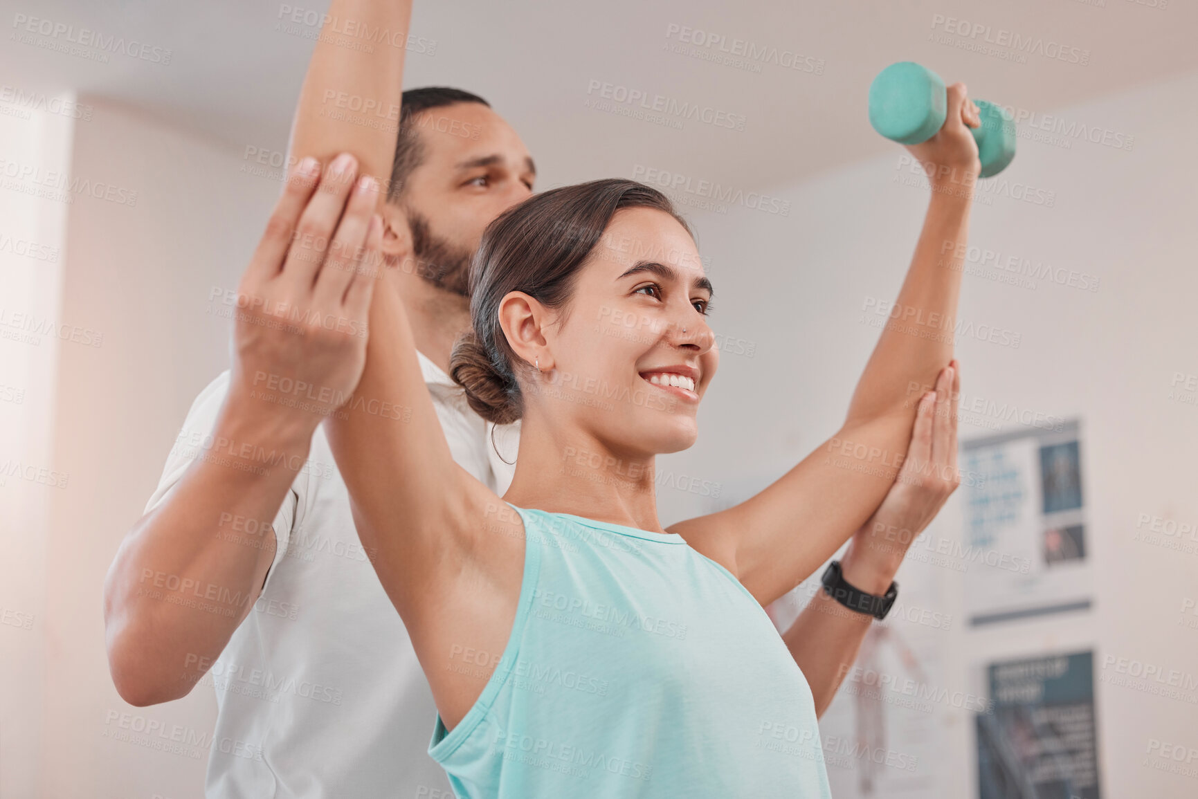 Buy stock photo Physical therapy, dumbbell and woman exercise during recovery with physical therapist, happy and hope at clinic. Physiotherapy, support and help from physiotherapist in consultation room for patient 