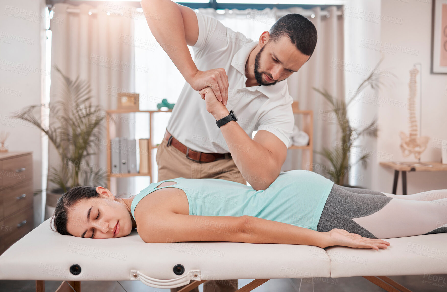 Buy stock photo Chiropractor, massage and physiotherapy treatment for back muscle with a woman patient. Consulting healthcare, wellness and chiropractic employee in a clinic helping with healthy body balance