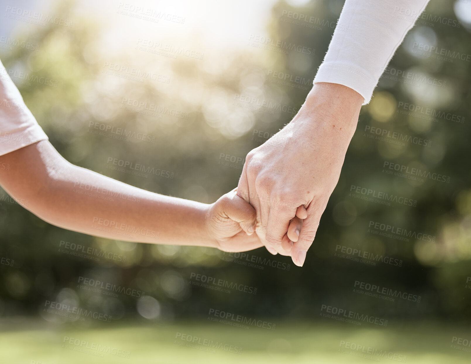 Buy stock photo Park, family and parent holding hands with child enjoying nature, summer holiday and weekend together. Bonding, support and person holding hand of young kid with affection, love and care in nature