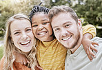 Happy, interracial family and smile portrait of a mother, girl and father with bonding in nature. Diversity, love and adoption care of a mom, kid and man hug together with youth happiness outdoor