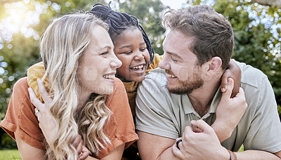 Buy stock photo Happy family, adoption and child hug parents while relax together, bonding and enjoy outdoor quality time on park field. Love, parenthood and diversity family in nature for peace, freedom and calm
