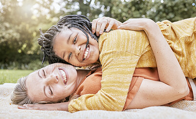 Buy stock photo Happy family, mother hug and nature of a interracial girl and mama with love in a picnic park. Portrait of happy, relax and smile of a mother and daughter together on a floor with diversity adoption