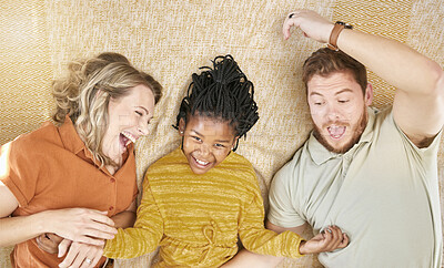 Buy stock photo Happy, adoption and interracial family relaxing, playing and bonding together in their home. Happiness, love and multiracial parents with their girl child resting in the living room of a modern house