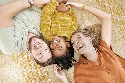 Buy stock photo Interracial family, adoption and home on floor with head together for love, happy and bonding. Mom, dad and african girl child lying with smile, happiness and diversity on carpet with top view