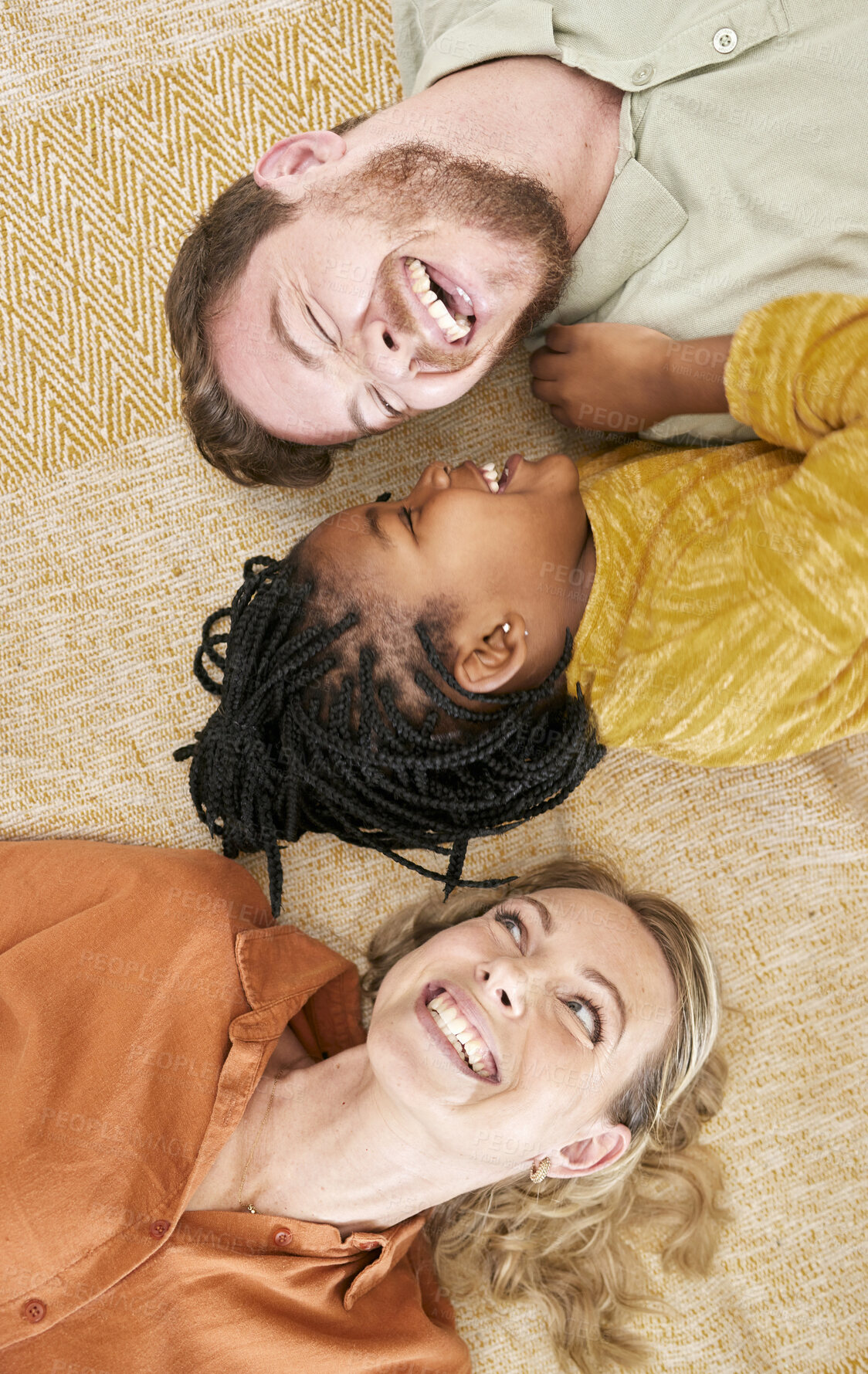 Buy stock photo Adoption and family with girl from above lying on floor, foster family together. Mom, dad and child lying on carpet playing, love and fun time in happy family home with trust and support.