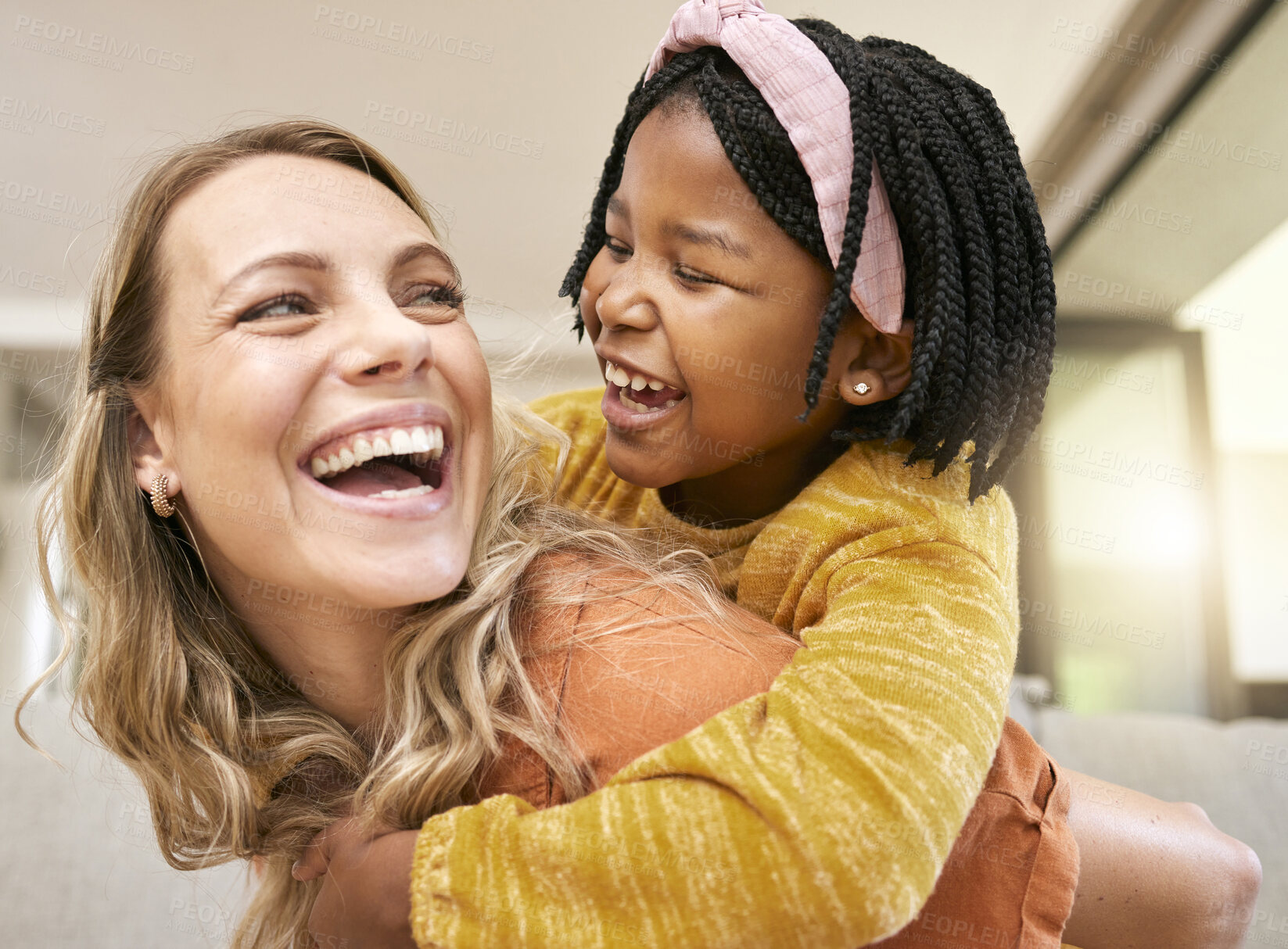 Buy stock photo Piggyback, bonding and mother and child in foster care on mothers day with love, smile and support. Family, interracial and African girl with a playful hug for her mom after adoption in their home