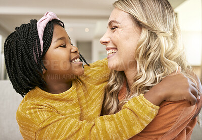 Buy stock photo Mother, adopted and daughter bonding  or hugging with love, care and affection for childhood embrace. Diverse woman and foster little girl hugging and having fun while in the family home