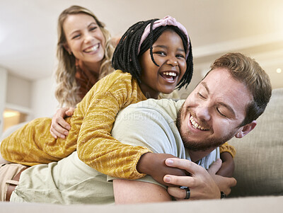Buy stock photo Adoption, love and family play, hug and happy smile, care and laugh together on the sofa in living room. African child, mother and father with happiness, fun and laughing on the couch in family home 