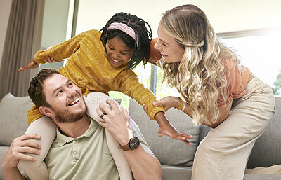 Buy stock photo Bonding, diversity and child with parents in foster care for love, happy and safety in a family home. Playful, smile and father, mother and African girl playing in an interracial house after adoption