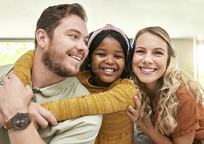 Buy stock photo Family, adoption and parents hug child, love and happiness with child care portrait, relax at family home. Happy, bonding and interracial people with foster care and mother, father with kid.